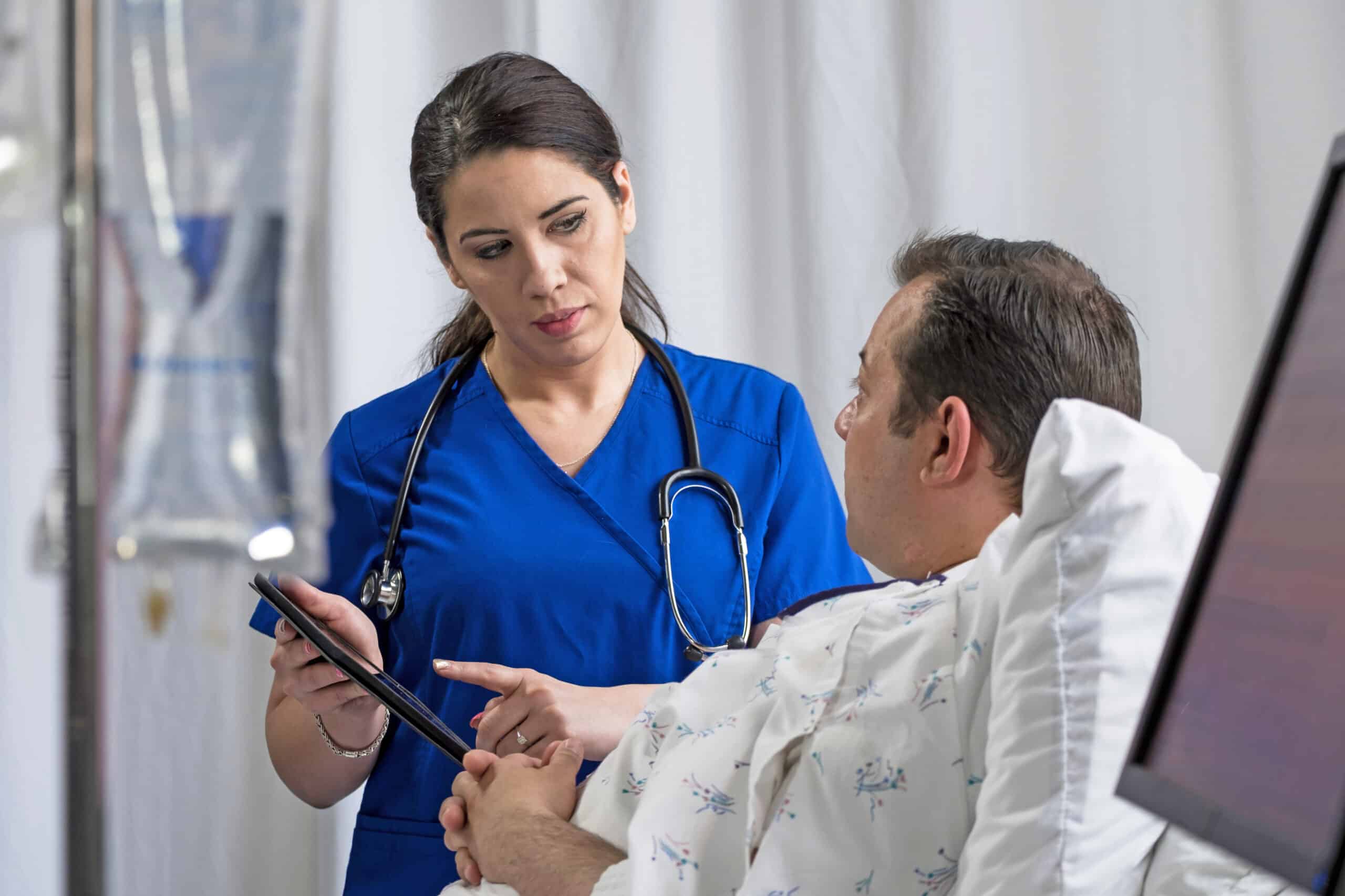 Physician using an ipad/tablet to give instructions to hospital