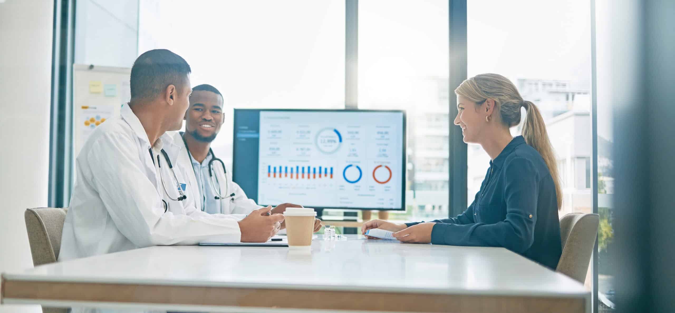 Teamwork, consulting and doctors with patient in hospital in meeting for help or assistance. Healthcare documents, data charts and woman in consultation with medical workers for vaccine information.